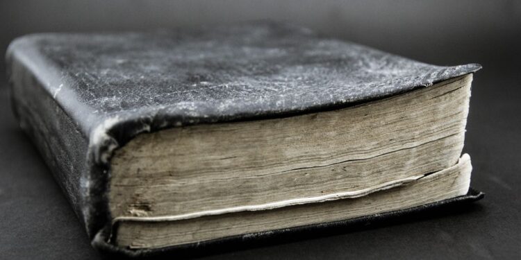 A dusty old book sitting on a table