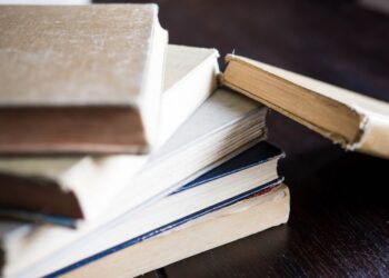 A stack of old books laying on a table