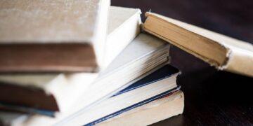 A stack of old books laying on a table